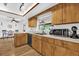 Functional kitchen with wood cabinets, a large window, and an open design at 511 Mobley Dr, Deltona, FL 32725