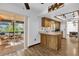 Bright kitchen area with a breakfast bar, wood cabinetry, and sliding glass doors leading to a patio at 511 Mobley Dr, Deltona, FL 32725