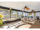 Large sun room with lots of natural light, wood-look floors, and a hammock at 511 Mobley Dr, Deltona, FL 32725