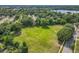 Expansive aerial view showcasing the community's green spaces, mature trees, and nearby lake at 5312 Kingswood Dr, Orlando, FL 32810