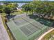 Aerial view showcasing tennis and basketball courts amidst green trees at 5312 Kingswood Dr, Orlando, FL 32810