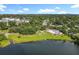 Aerial shot of lakefront area featuring a pool, pond, dock, and green space that invites relaxation and recreation at 5312 Kingswood Dr, Orlando, FL 32810