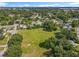 Aerial view showcasing the community's expansive green space, surrounded by lush trees and neighborhood homes at 5312 Kingswood Dr, Orlando, FL 32810