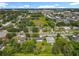 An aerial view of a suburban street surrounded by residential houses and dense tree cover at 5312 Kingswood Dr, Orlando, FL 32810