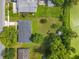 Aerial view of a house with a large, grassy backyard bordered by trees and a canal at 5312 Kingswood Dr, Orlando, FL 32810