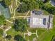 Overhead aerial view of a community pool and basketball court surrounded by greenery and sidewalks in a recreational area at 5312 Kingswood Dr, Orlando, FL 32810