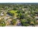 Aerial shot of a community featuring a playground, large open field, tree-lined streets, and a mix of residential homes at 5312 Kingswood Dr, Orlando, FL 32810