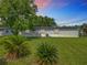 Green backyard featuring privacy, grass, and tropical landscaping at 5312 Kingswood Dr, Orlando, FL 32810