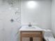 Elegant bathroom featuring marble tile, modern fixtures and a stylish vanity at 5312 Kingswood Dr, Orlando, FL 32810