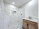 Modern bathroom featuring a marble tiled shower, elegant vanity, and stylish fixtures at 5312 Kingswood Dr, Orlando, FL 32810
