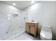Modern bathroom featuring sleek white tiles, a stylish vanity, and a walk-in shower at 5312 Kingswood Dr, Orlando, FL 32810