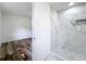 Bathroom featuring stylish marble tile and an adjacent room with wood flooring at 5312 Kingswood Dr, Orlando, FL 32810