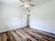 This bedroom has wood-look flooring, white walls, and a ceiling fan at 5312 Kingswood Dr, Orlando, FL 32810