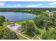 Aerial view of community amenities, including a pool, park, walking paths, and lake access for residents' enjoyment at 5312 Kingswood Dr, Orlando, FL 32810