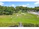 Expansive community park with lush greenery, walking paths, swimming pool and access to the waterfront with a wooden dock at 5312 Kingswood Dr, Orlando, FL 32810