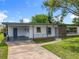 Charming single-story home with manicured lawn, mature trees, and covered entry at 5312 Kingswood Dr, Orlando, FL 32810