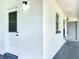 A clean exterior view showing the home's white brickwork, doors, and covered entry at 5312 Kingswood Dr, Orlando, FL 32810