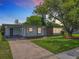 Charming single-story home featuring a well-manicured lawn and a brick accent wall at 5312 Kingswood Dr, Orlando, FL 32810