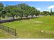 Well-maintained grassy lot features a full fence line and mature trees along the perimeter, offering privacy and charm at 5312 Kingswood Dr, Orlando, FL 32810