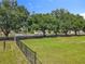 Grassy lot with mature trees bordering along streets, providing a natural privacy screen with ample sunshine, perfect for new construction at 5312 Kingswood Dr, Orlando, FL 32810