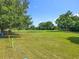 Spacious grassy lot surrounded by mature trees, offering a blend of privacy and sunshine for building or recreation at 5312 Kingswood Dr, Orlando, FL 32810