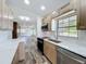 Modern kitchen featuring stainless steel appliances and marble countertops, seamlessly connected to the living area at 5312 Kingswood Dr, Orlando, FL 32810