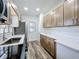 Well-lit kitchen featuring wood cabinets, quartz countertops, and modern stainless steel appliances at 5312 Kingswood Dr, Orlando, FL 32810