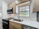 Kitchen featuring wood cabinets, quartz countertops, and a stainless steel sink at 5312 Kingswood Dr, Orlando, FL 32810