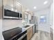 Modern kitchen with stainless steel appliances, quartz countertops and wood cabinets at 5312 Kingswood Dr, Orlando, FL 32810