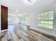 Bright living room with wood flooring and large windows offering plenty of natural light at 5312 Kingswood Dr, Orlando, FL 32810