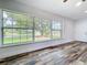 Spacious living room featuring hardwood floors and a large window, offering a view of the front yard at 5312 Kingswood Dr, Orlando, FL 32810