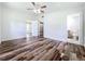Spacious main bedroom with ceiling fan, plank flooring, en suite bathroom, and walk-in closet at 5312 Kingswood Dr, Orlando, FL 32810