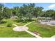 Community park with walking paths, benches, lush landscaping, and mature trees at 5312 Kingswood Dr, Orlando, FL 32810