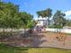 Community playground with swings, climbing structure, and climbing wall for Gathering fun at 5312 Kingswood Dr, Orlando, FL 32810