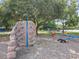 Community playground with a rock-climbing wall, see-saws, and natural shade trees at 5312 Kingswood Dr, Orlando, FL 32810