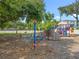 Community playground featuring a climbing wall, swings, and various play structures under mature trees at 5312 Kingswood Dr, Orlando, FL 32810