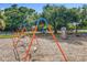 Playground with swings, climbing wall, and other features set amongst mature trees at 5312 Kingswood Dr, Orlando, FL 32810