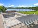 Community pool area featuring an empty pool, shade structure, lake views, and well-maintained grounds at 5312 Kingswood Dr, Orlando, FL 32810