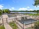 Community pool area featuring an empty pool, seating, lake views, and serene surroundings at 5312 Kingswood Dr, Orlando, FL 32810