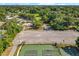 Aerial view of community amenities featuring a playground, basketball court, tennis courts, and a parking area surrounded by lush greenery at 5312 Kingswood Dr, Orlando, FL 32810