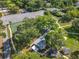 Aerial view featuring tennis courts, a playground, a walkway, a covered area, and lush trees in a community setting at 5312 Kingswood Dr, Orlando, FL 32810