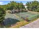 Aerial view of a community basketball court and tennis court, offering recreational opportunities for residents at 5312 Kingswood Dr, Orlando, FL 32810
