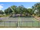 Aerial view of a community tennis court complex with mature trees offering shade at 5312 Kingswood Dr, Orlando, FL 32810