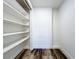 This walk-in closet has built in shelves and modern wood-look vinyl flooring at 5312 Kingswood Dr, Orlando, FL 32810