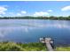 Picturesque lake view with a wooden dock, ideal for quiet contemplation and access to the serene waters at 5312 Kingswood Dr, Orlando, FL 32810