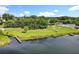 Aerial view of waterfront with dock, lush greenery, and amenities like a pool, providing a vibrant and serene living environment at 5312 Kingswood Dr, Orlando, FL 32810