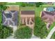 An aerial view showcases the home's roof, landscaping, driveway, and proximity to neighboring residences at 651 Regina Cir, Oakland, FL 34787