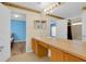 Well-lit bathroom with double sinks, large mirror, and tile floors; access to shower and bedrooms at 651 Regina Cir, Oakland, FL 34787