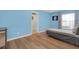 Airy bedroom with light blue walls, wood-look floors, a single bed, and closet access at 651 Regina Cir, Oakland, FL 34787