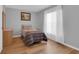 Bedroom features a cozy bed, a wood dresser, and large window with sheer curtains at 651 Regina Cir, Oakland, FL 34787